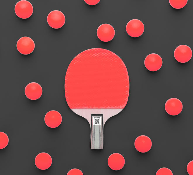 flat lay image of table tennis paddle and many balls central composition